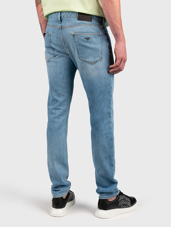Blue jeans with metal logo accent - 2