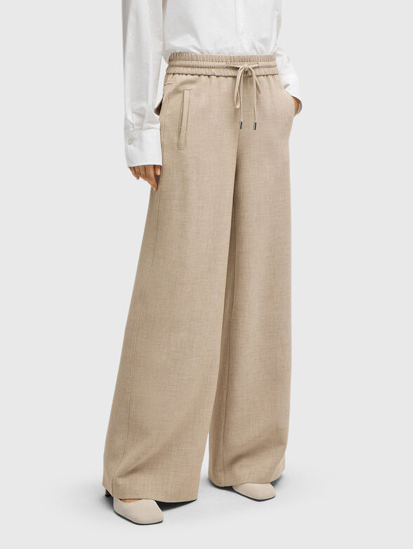 Beige trousers ties at the waist - 1