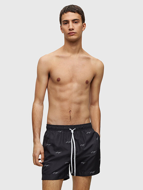 Black beach shorts with logo motifs - 1