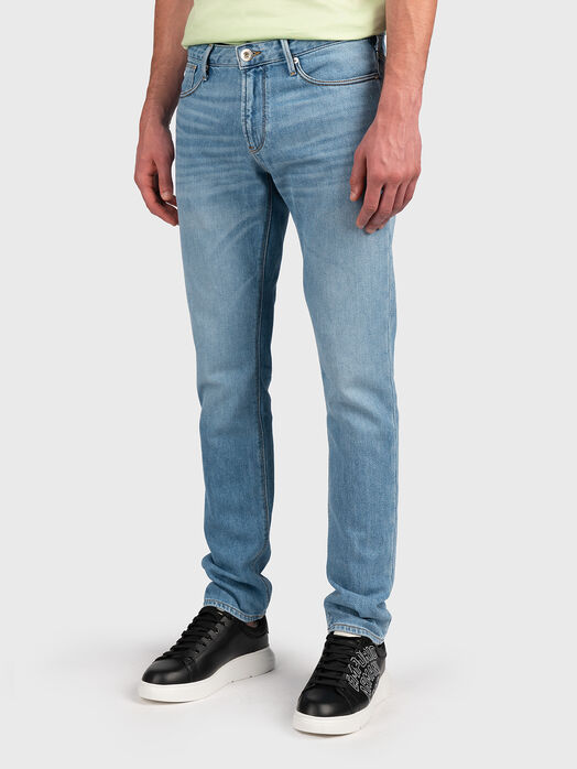 Blue jeans with metal logo accent