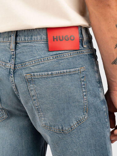 Jeans with washed effect and logo - 3