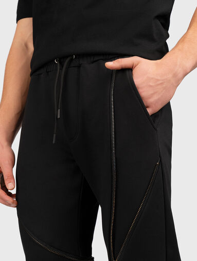 Sports trousers with accent zips - 4