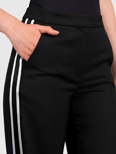 Trousers with flared legs with slits - 4