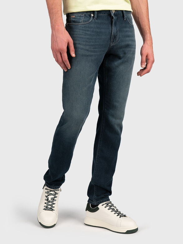 Blue jeans with metal logo accent - 1