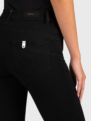 Black high-waisted jeans with hem decorations - 3