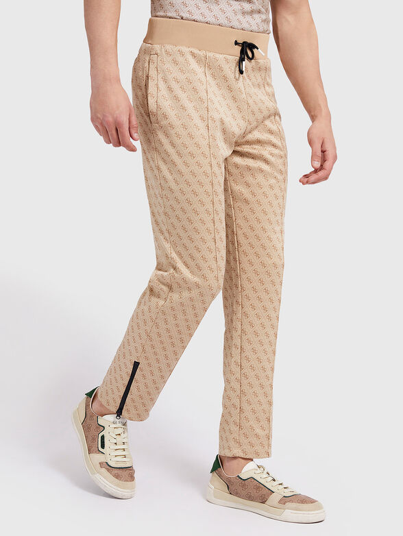 Monogram logo print sweatpants in beige - 1