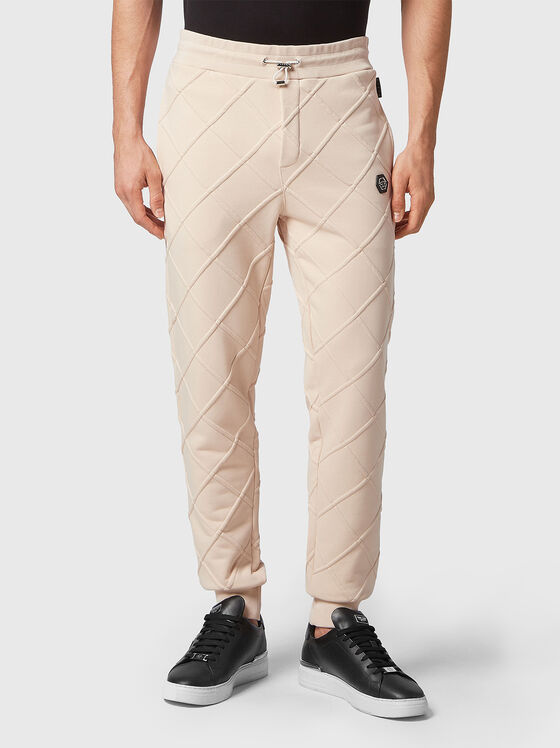 Beige sports pants with embossed texture - 1