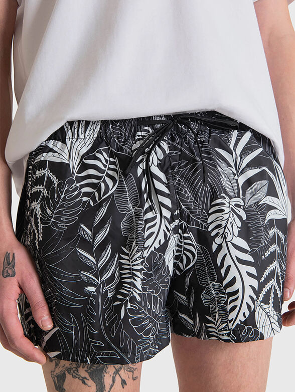 Beach shorts with floral accent - 1