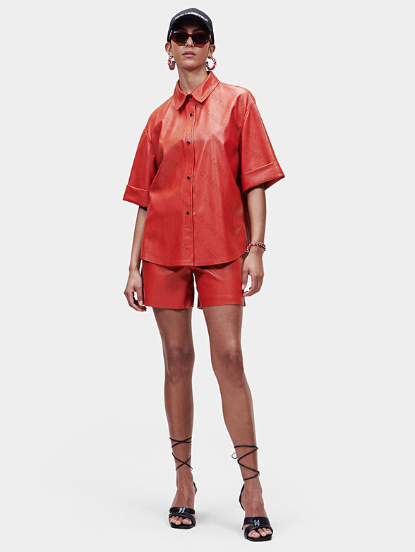 Black faux leather shirt with perforated logos - 1