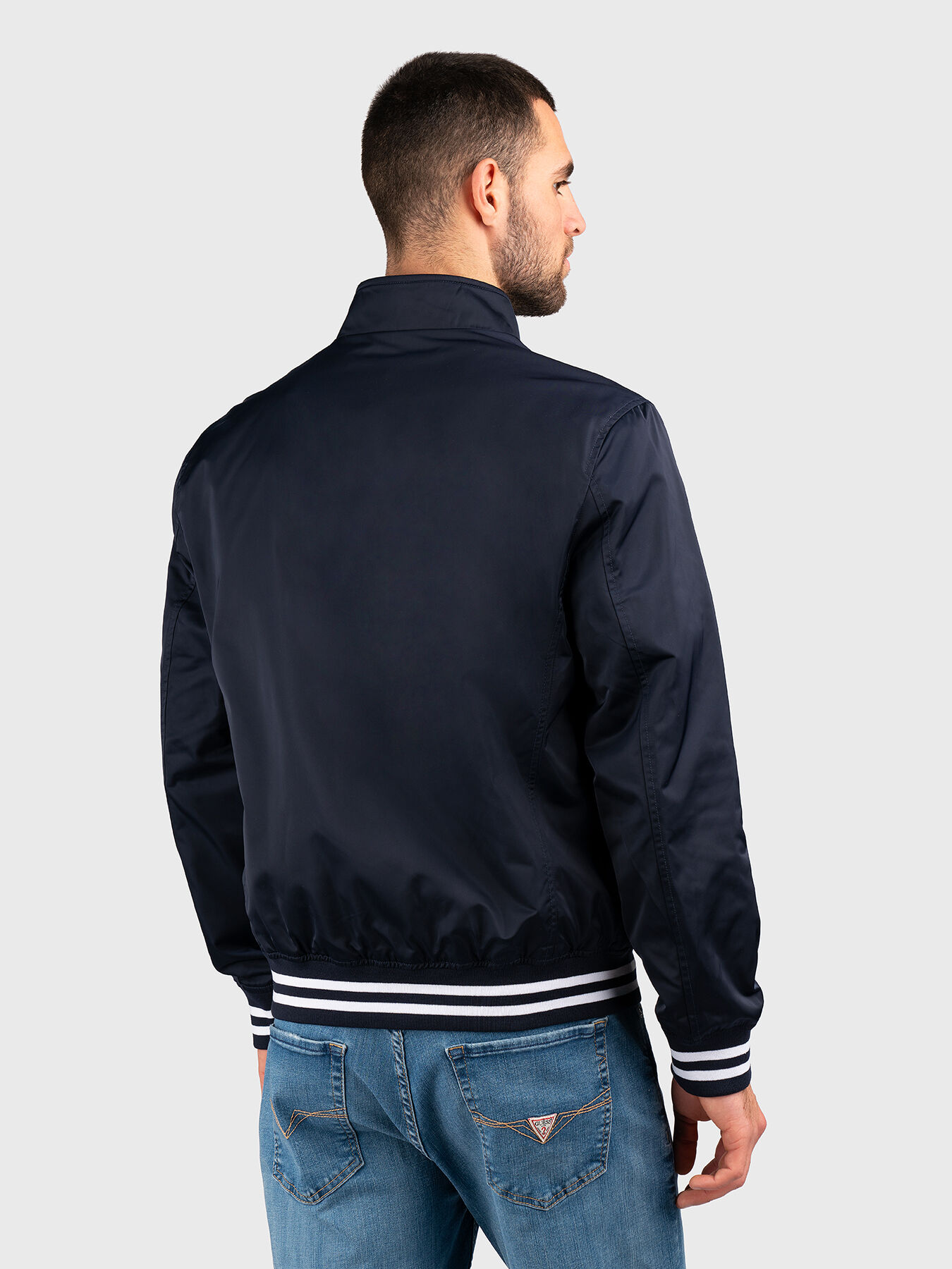 Black jacket with zip and logo patch brand GUESS