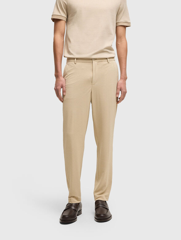 Textured trousers in beige - 1