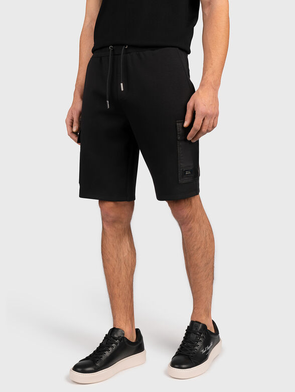 Short black pants with accent pocket - 1
