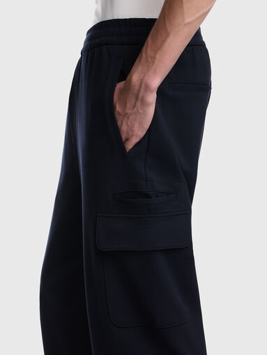 Dark blue trousers with a textured pattern - 4