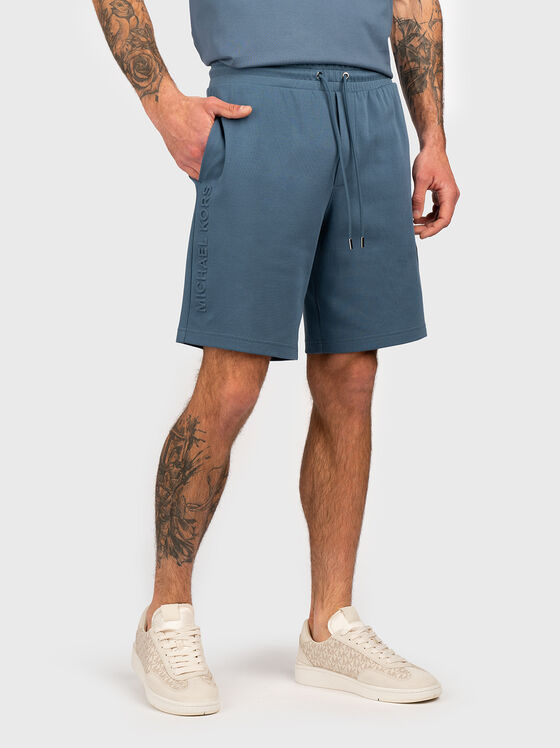 Beige shorts with embossed logo - 1