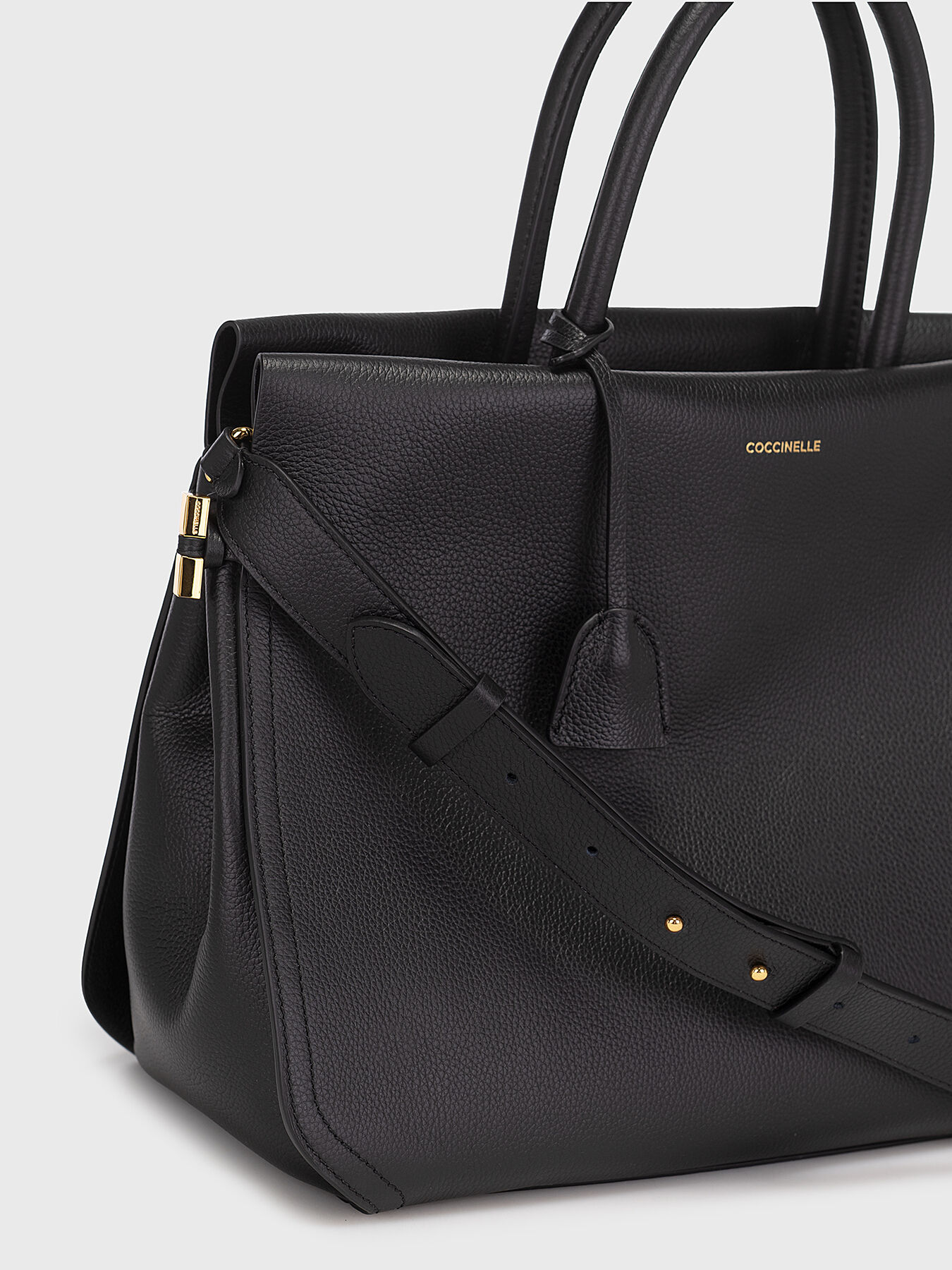 Black leather bag with gold details brand COCCINELLE