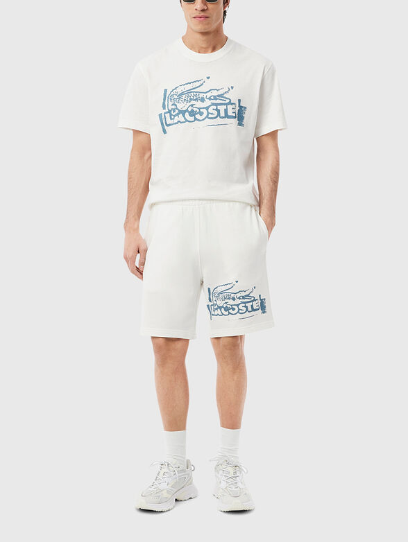 Cotton shorts with logo print in ecru - 1