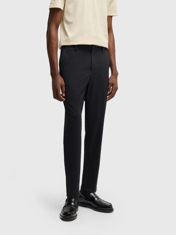 Textured trousers in beige - 1
