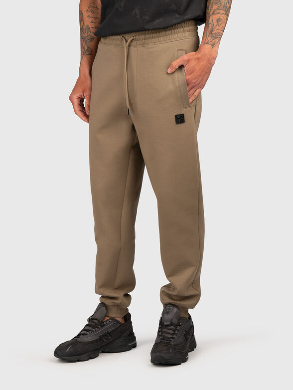 Cotton trousers with ties and logo detail - 1