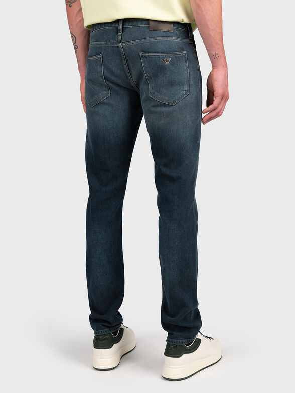 Blue jeans with metal logo accent - 2