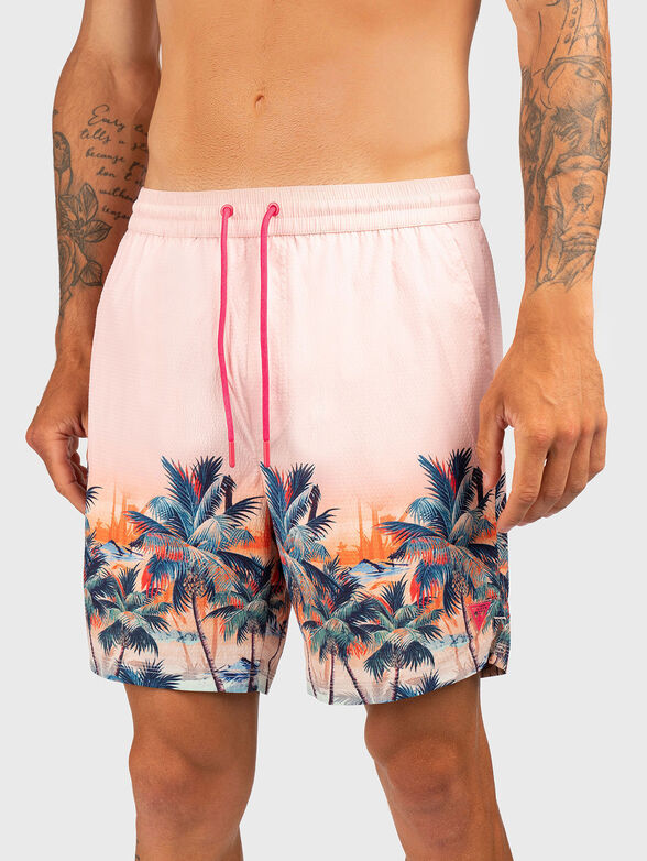 Pink beach shorts with tropical print - 1