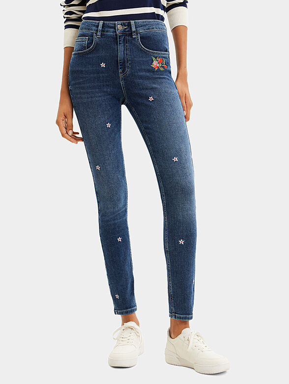 Blue jeans with floral motifs - 1