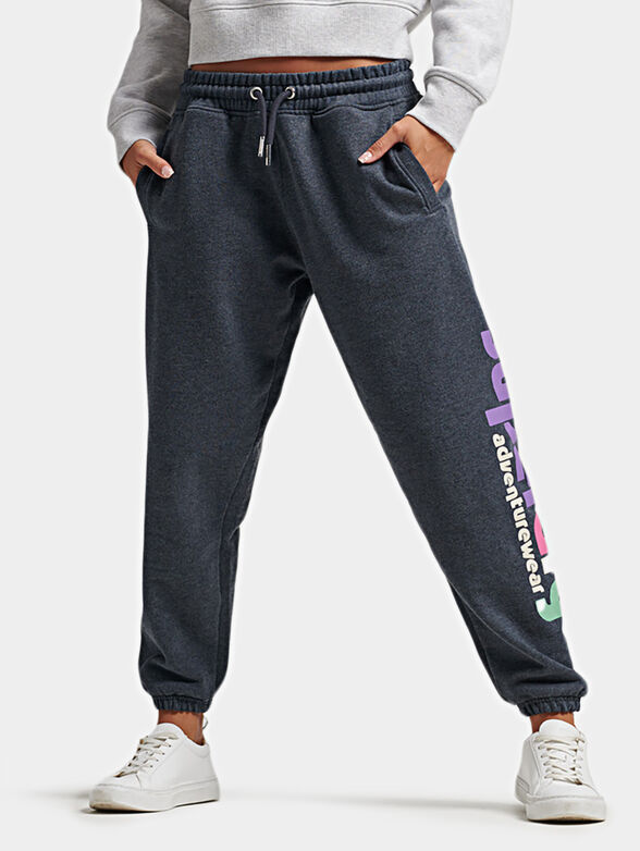 Blue sports pants with colorful logo print - 1
