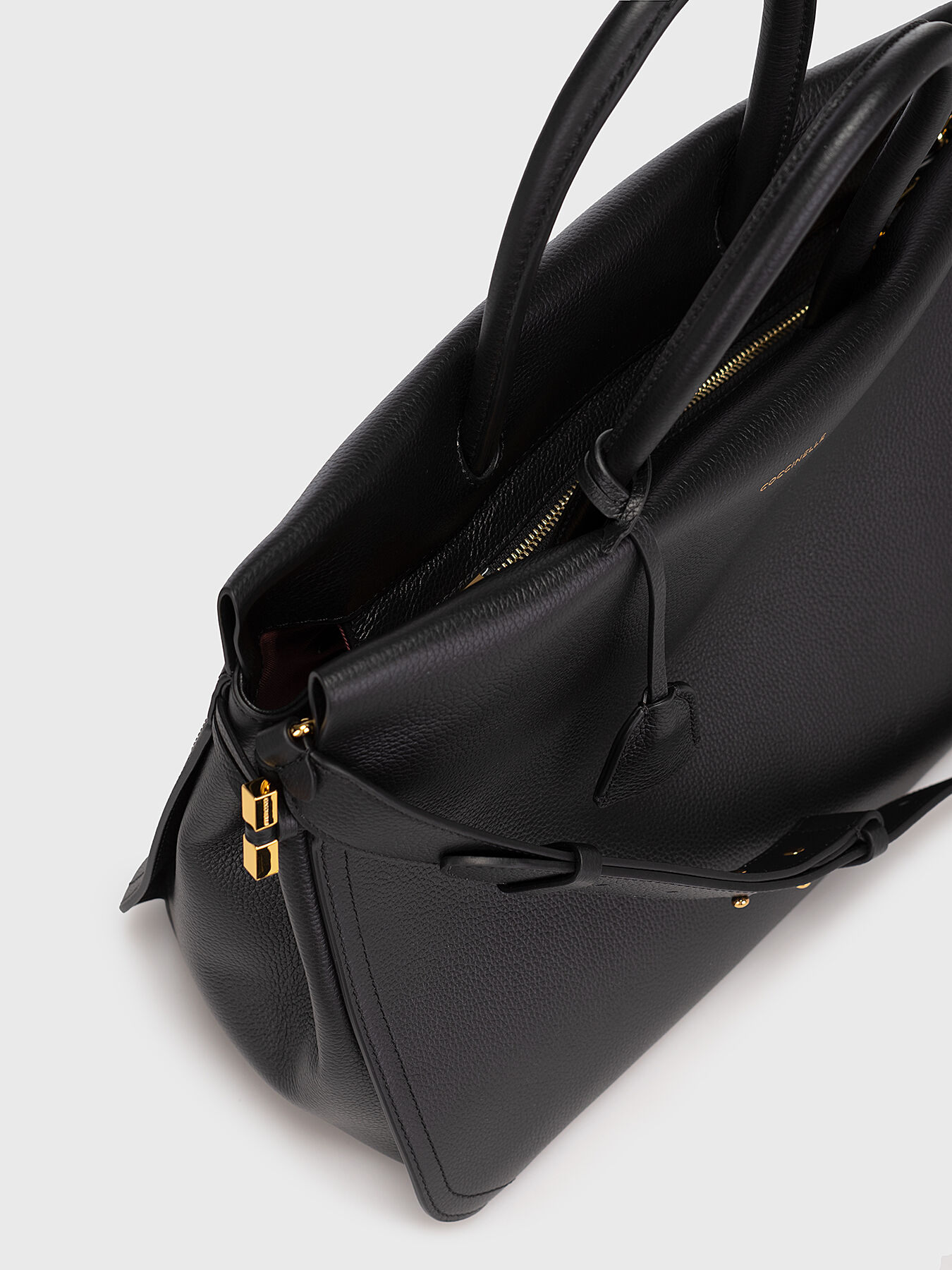 Black leather bag with gold details brand COCCINELLE