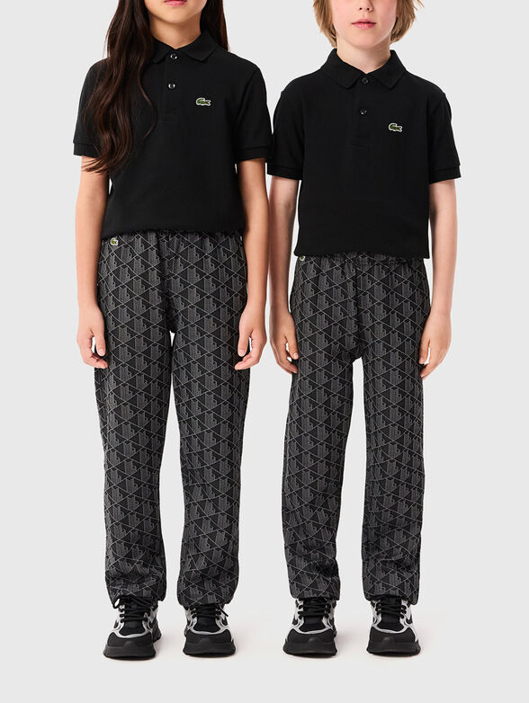 Black sports trousers with geometric pattern - 1