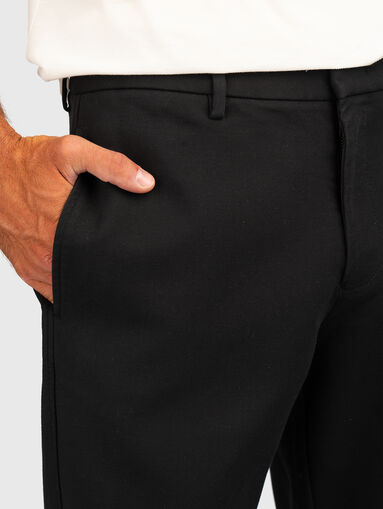 Trousers with pockets and logo detail - 4