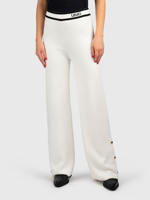 Pants with buttons on the legs