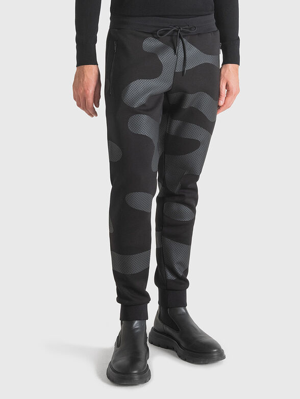 Sports trousers with camouflage print - 1