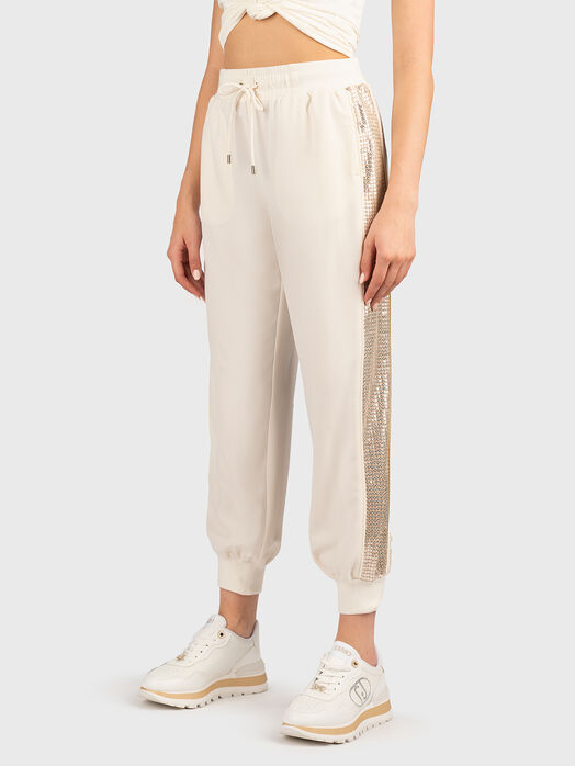 Sports trousers with sequins and logo