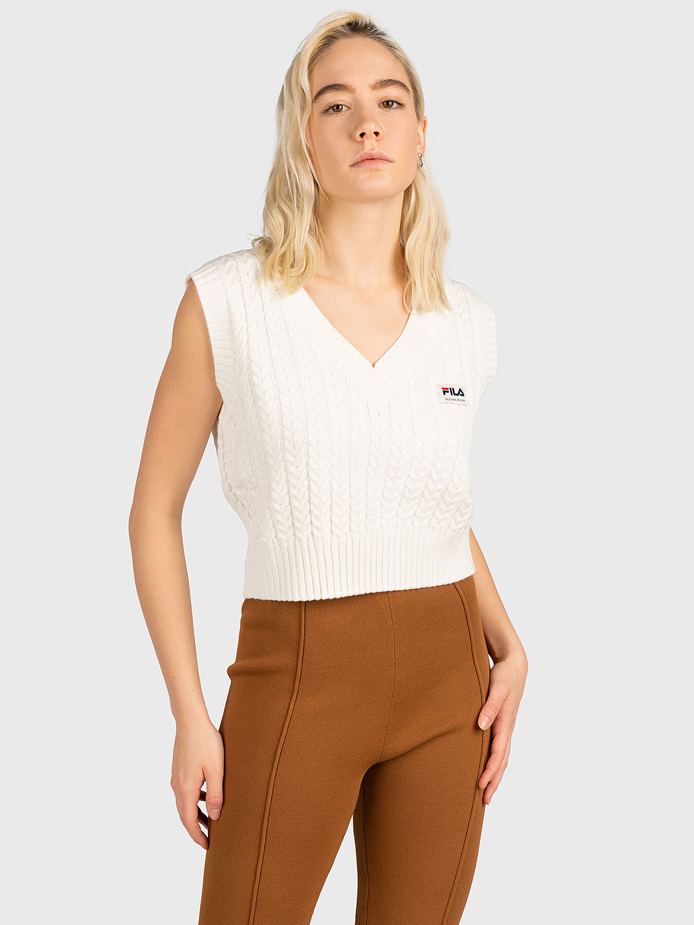 White sleeveless sweater on sale
