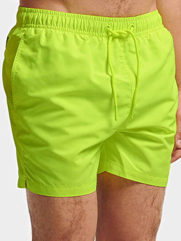Beach shorts in neon green color - 1